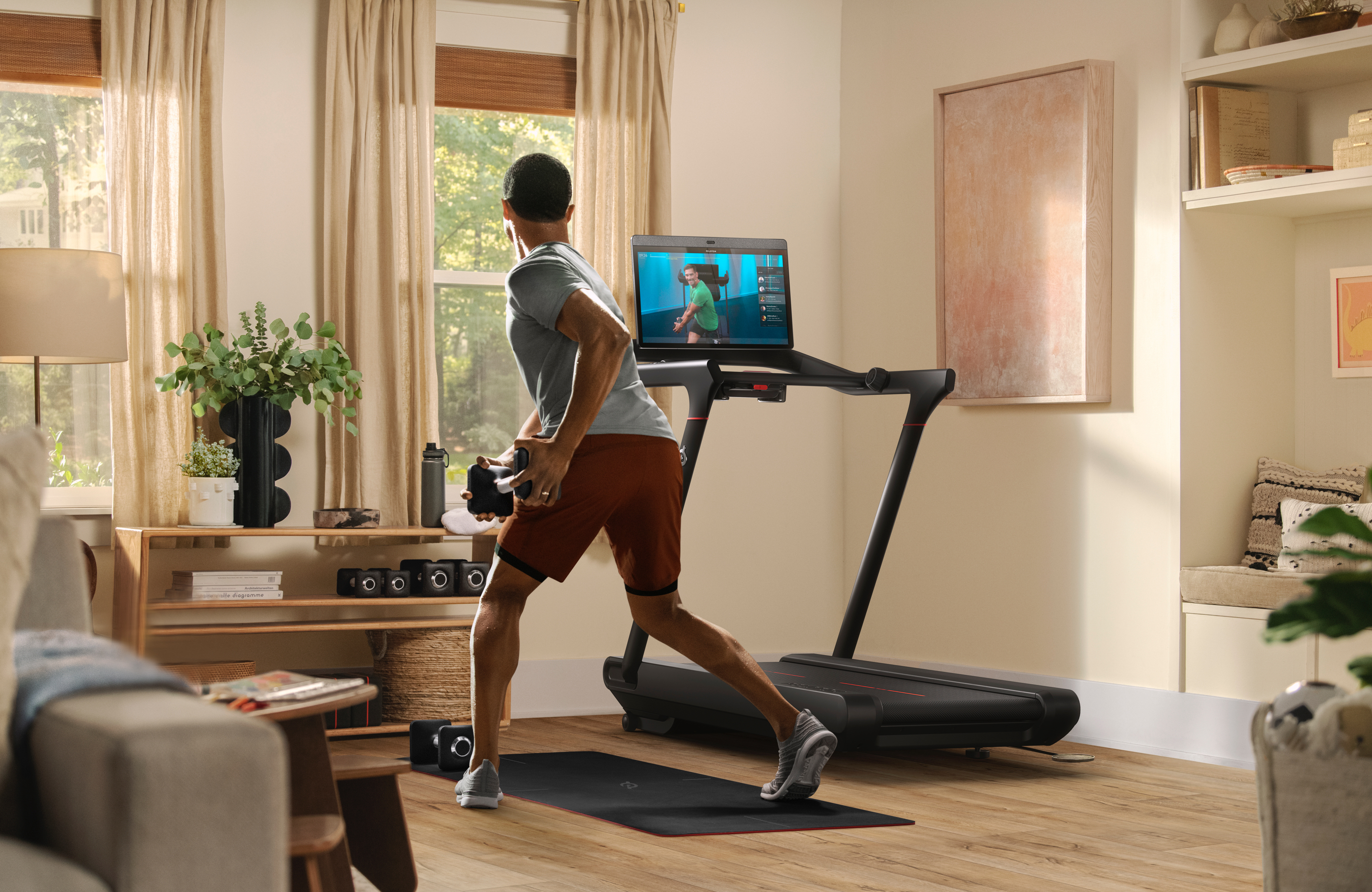 A man works out in front of Peloton's Tread.