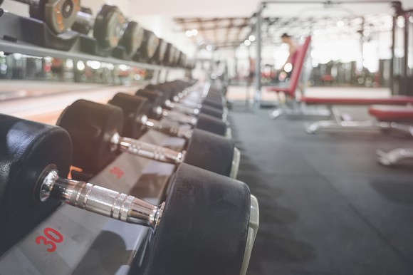 A rack of barbells are pictured in a gym setting.