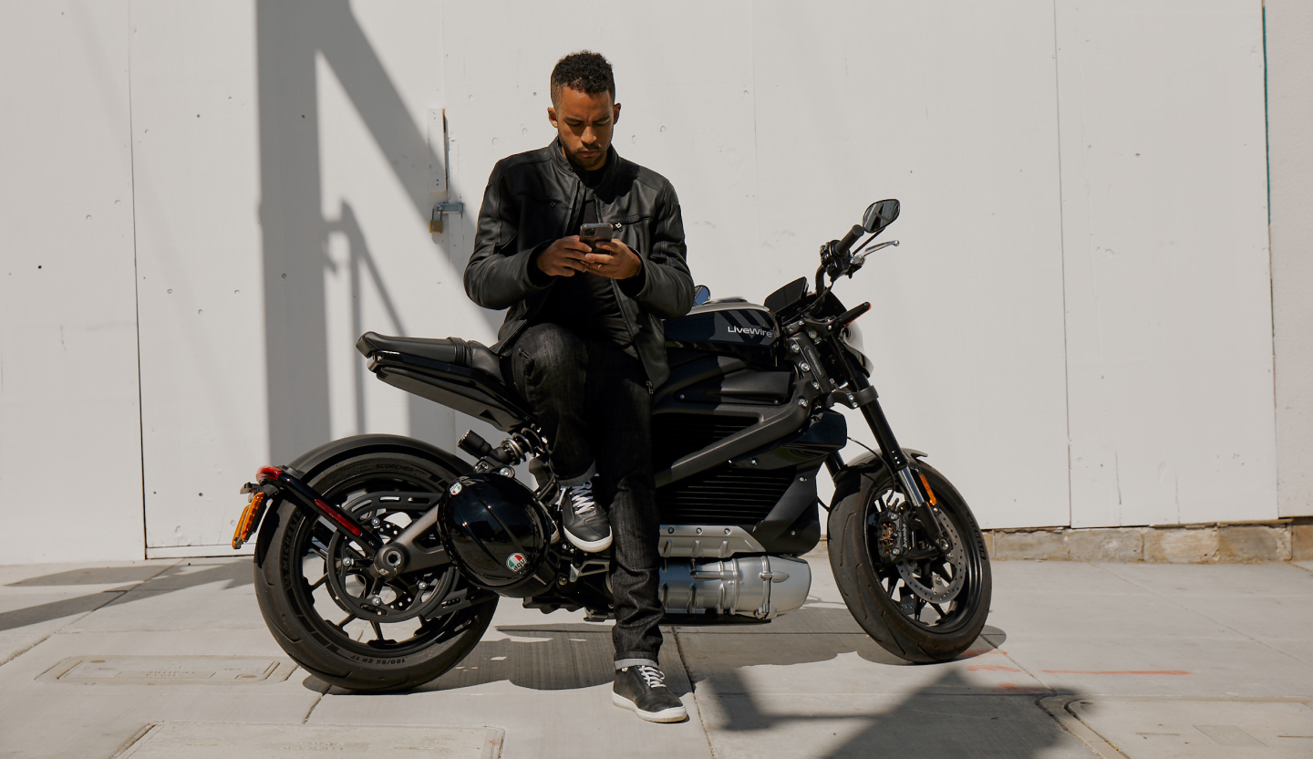 Man leaning against LiveWire One motorcycle