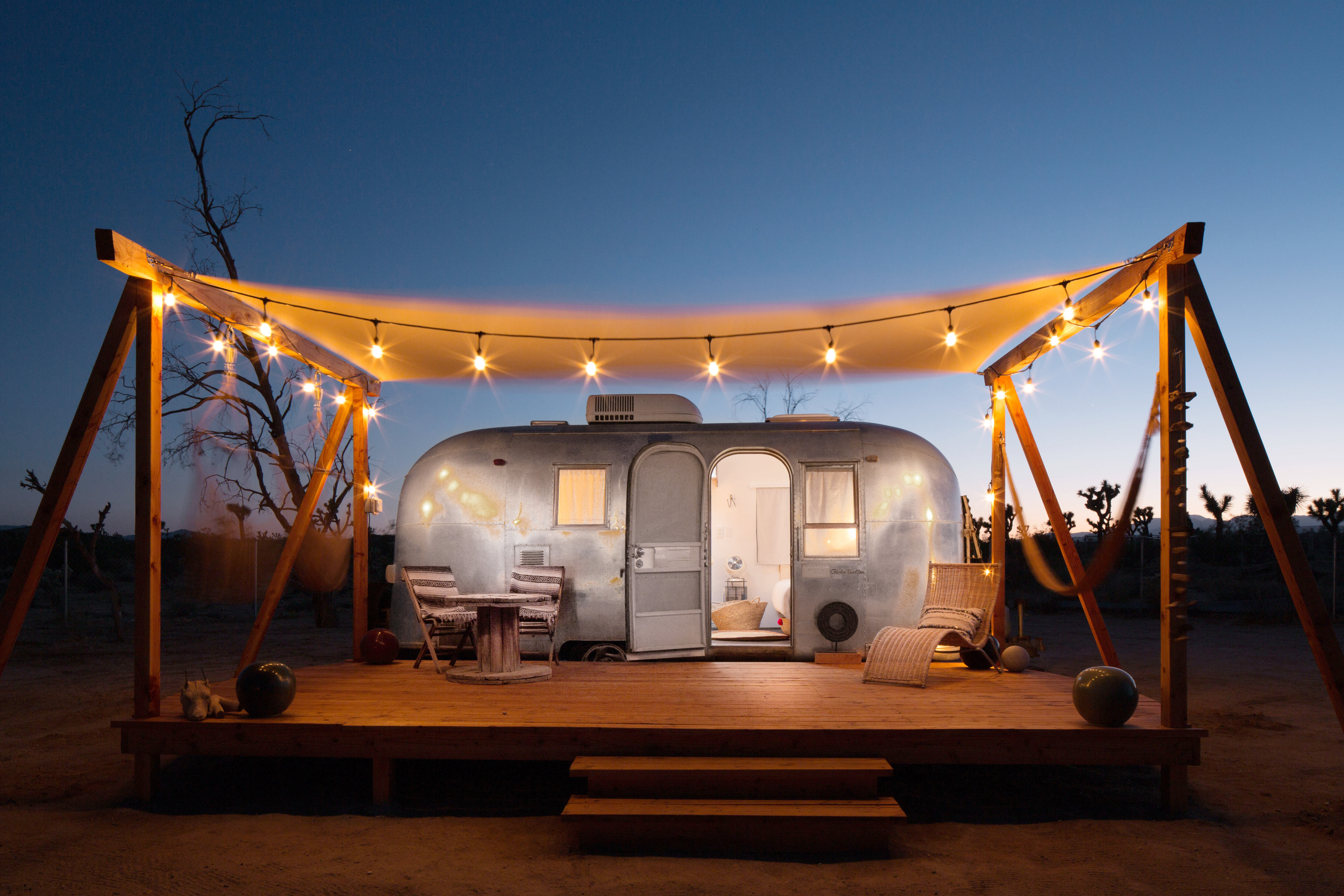 An Airstream trailer under a canopy