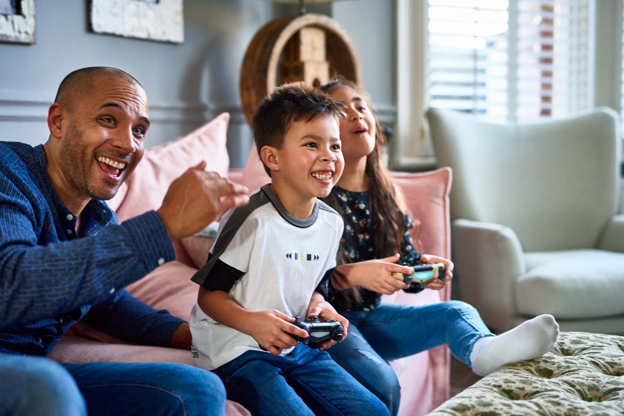 Children playing game as an adult beside them cheers.