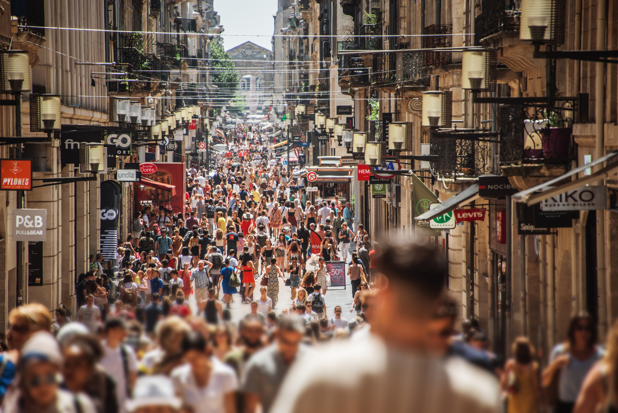 A crowded street lined with shops