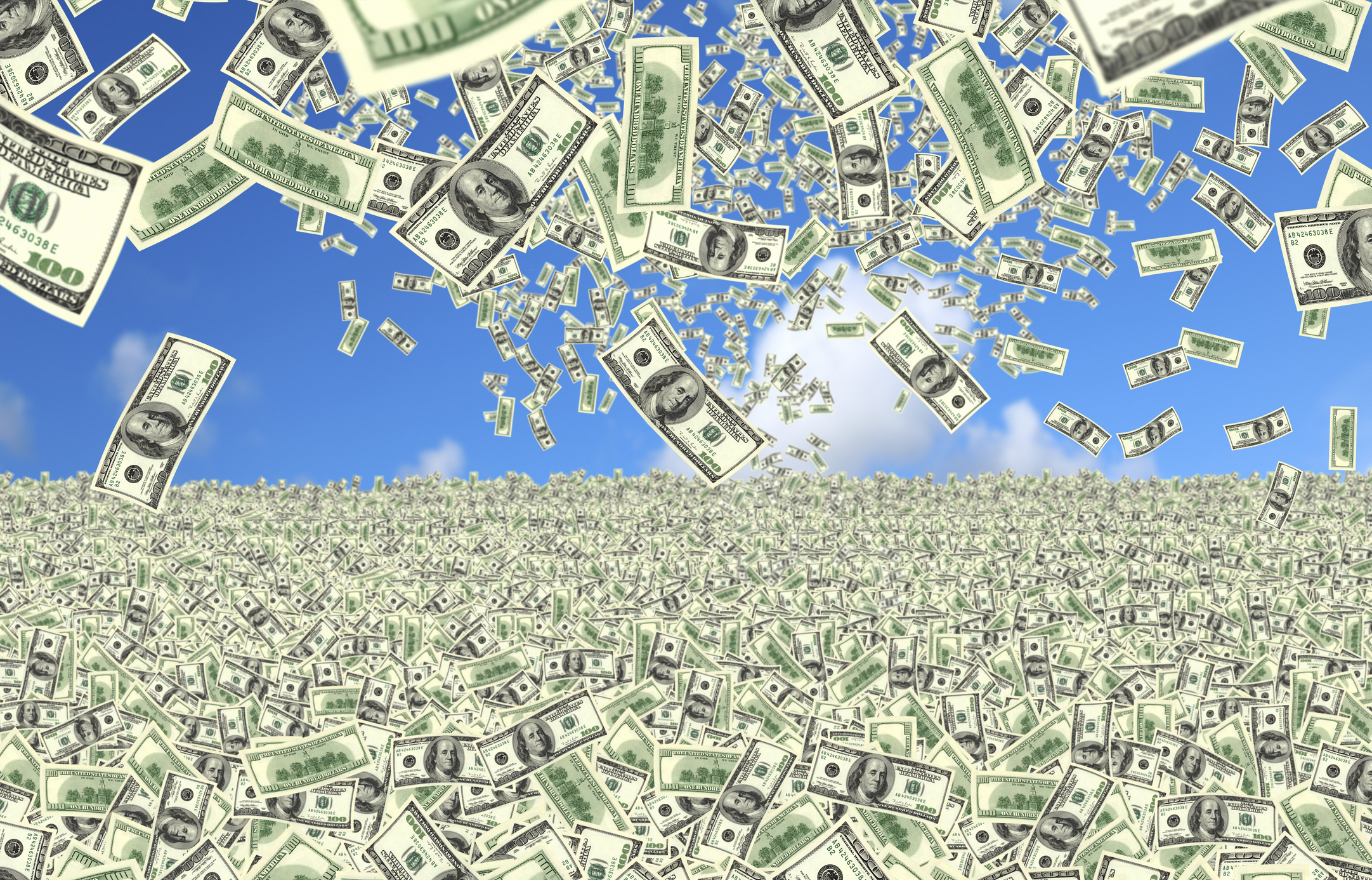 Hundred-dollar bills falling from the sky into a field of money.
