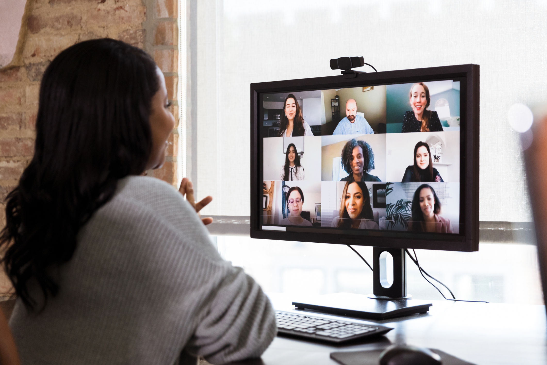 People having a meeting via a video conference.