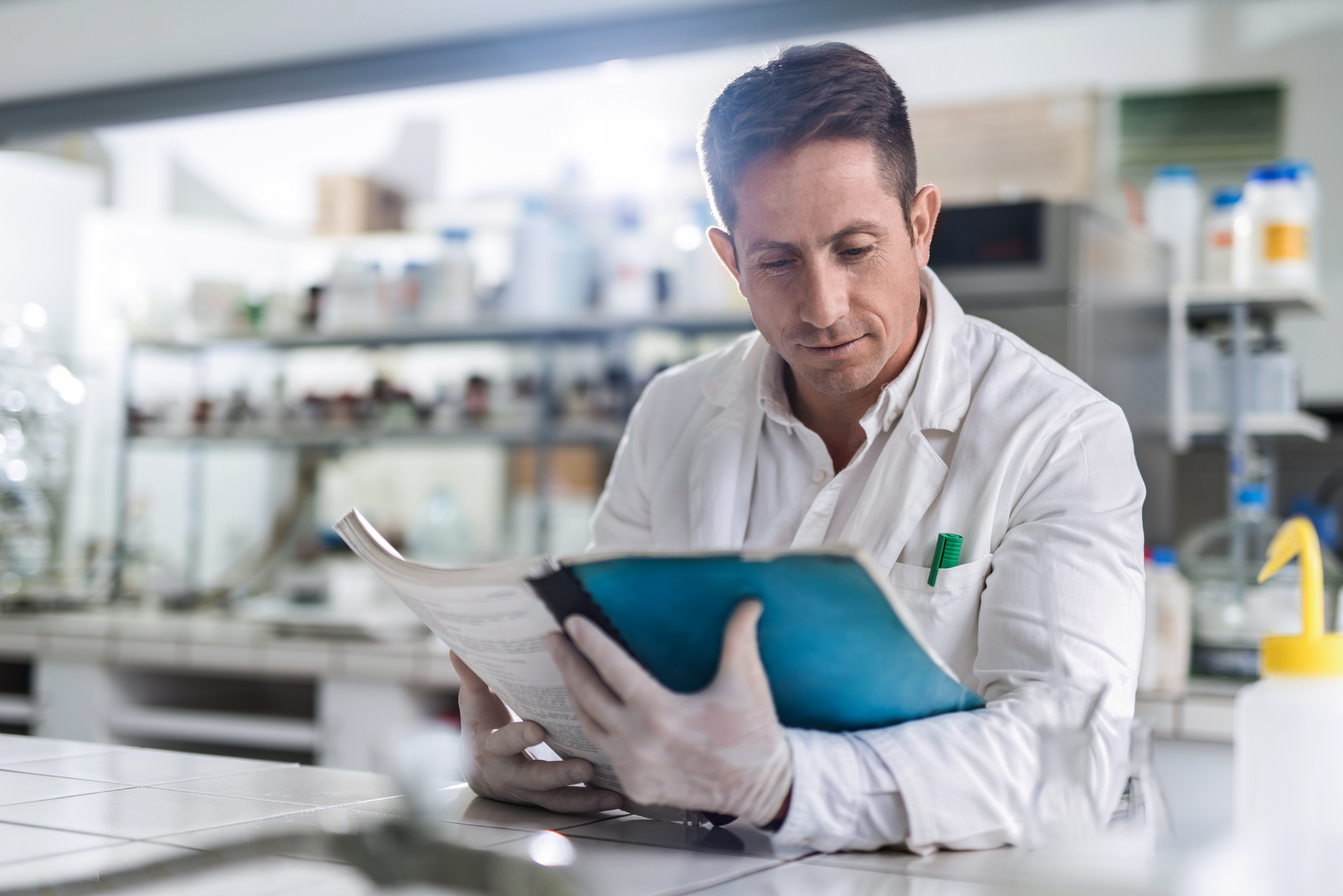 Scientist reading a report in a laboratory.