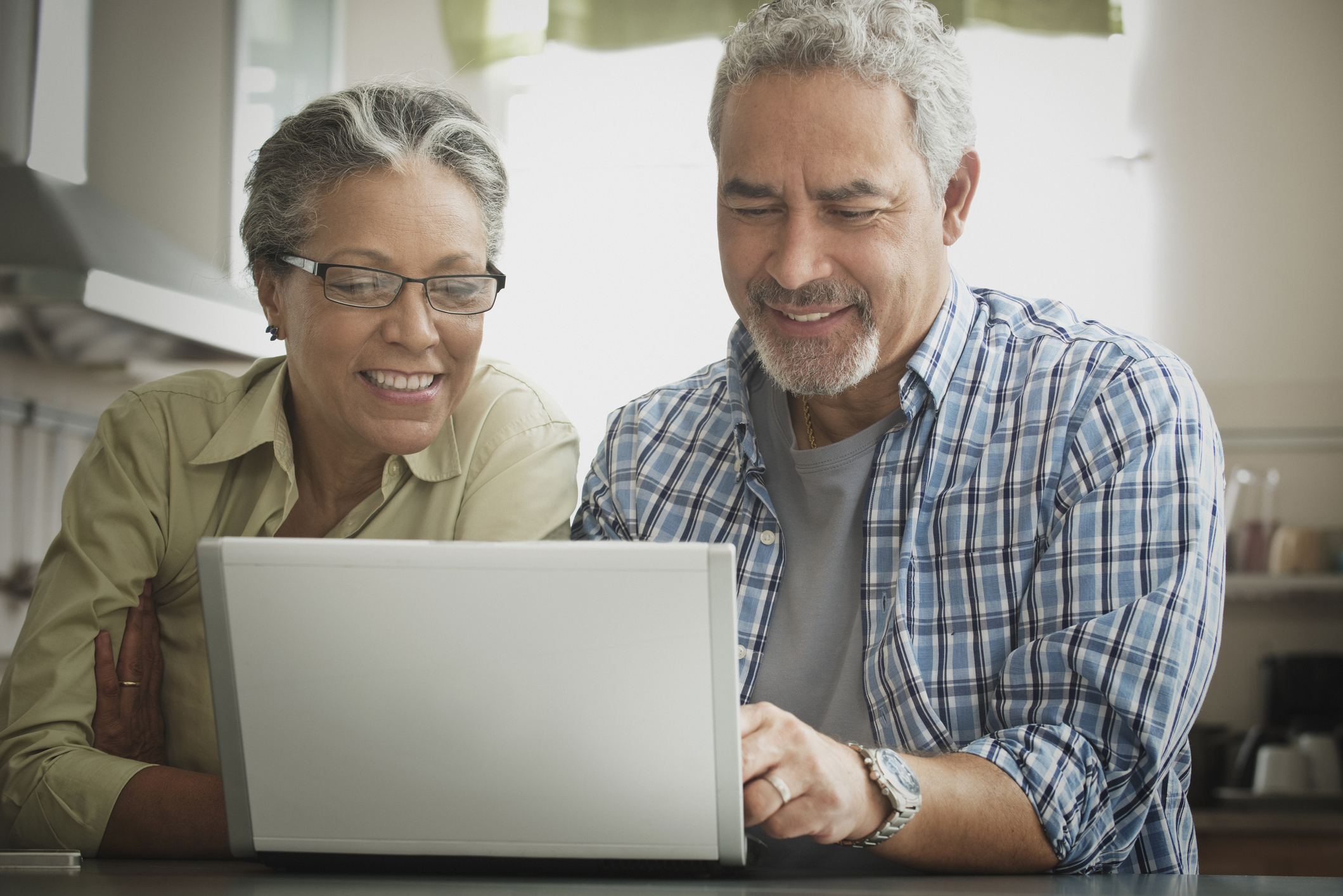 Two people looking at a laptop.