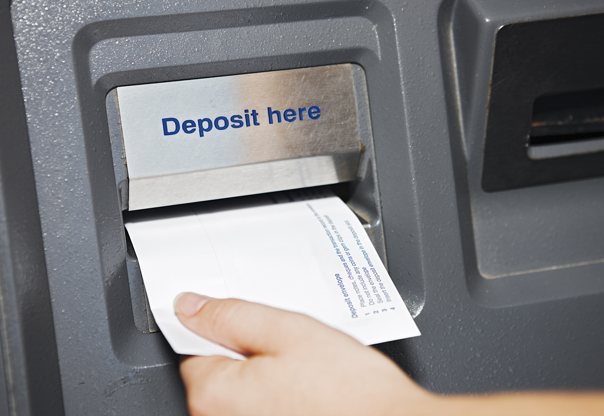 A bank customer makes a deposit.