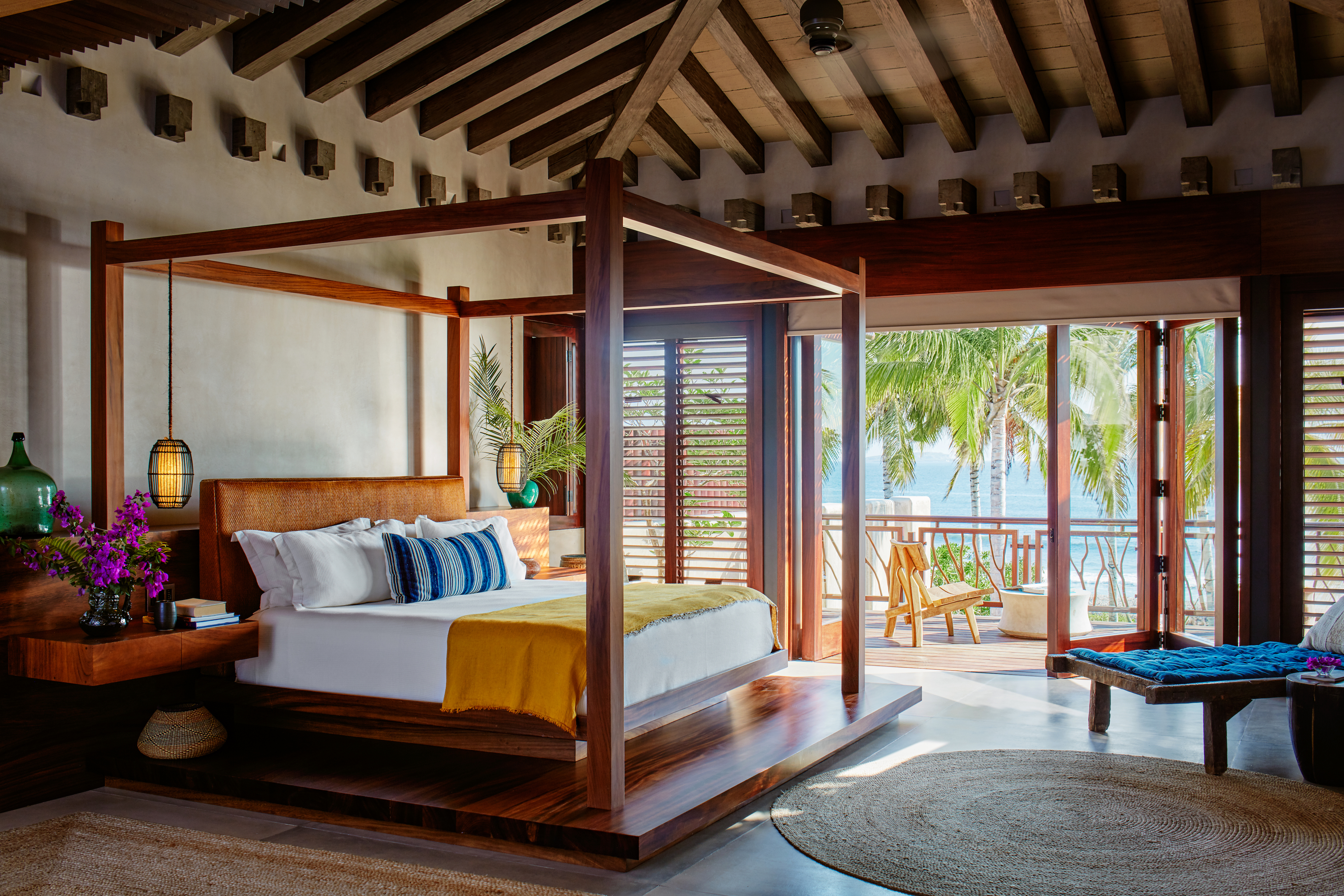 Luxury lodgings, featuring a wood-themed room with a view of the ocean.