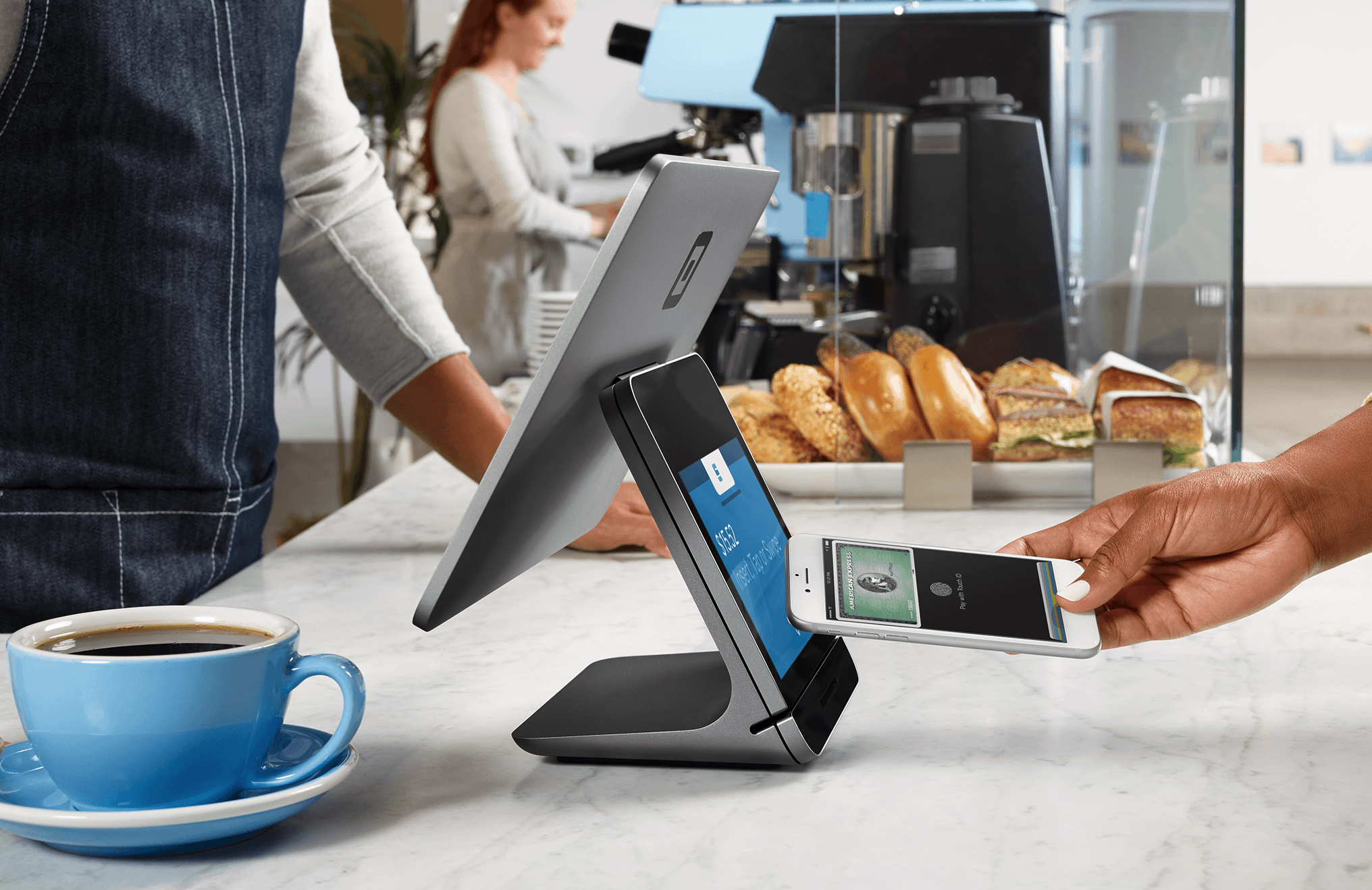 Person using smartphone to make a payment at a Square register.