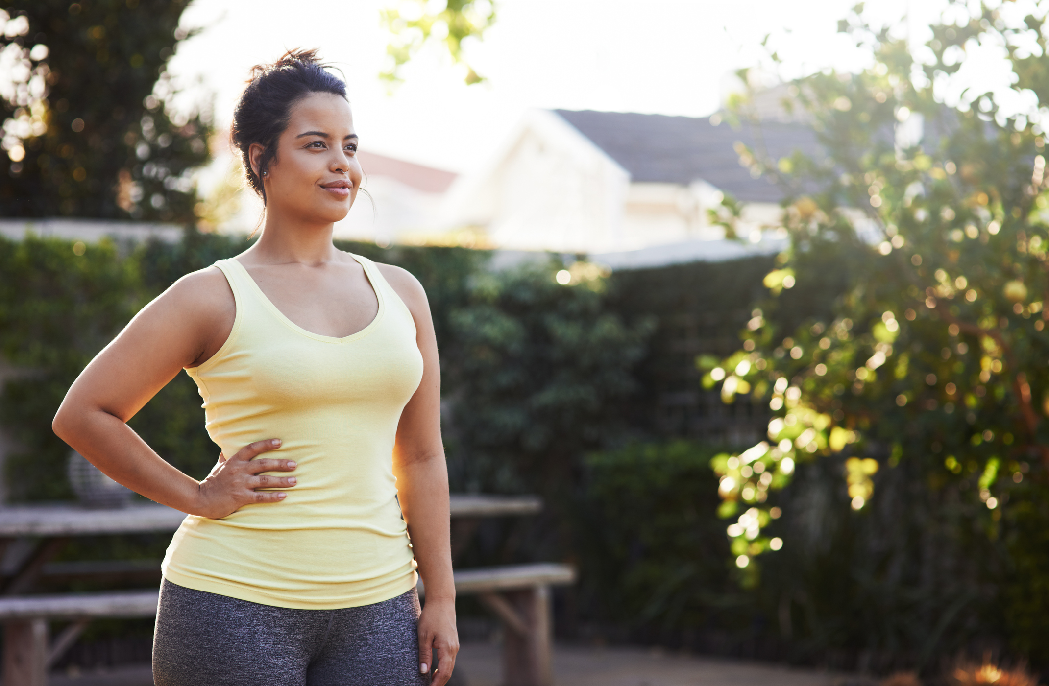 Smiling adult exercising outside.