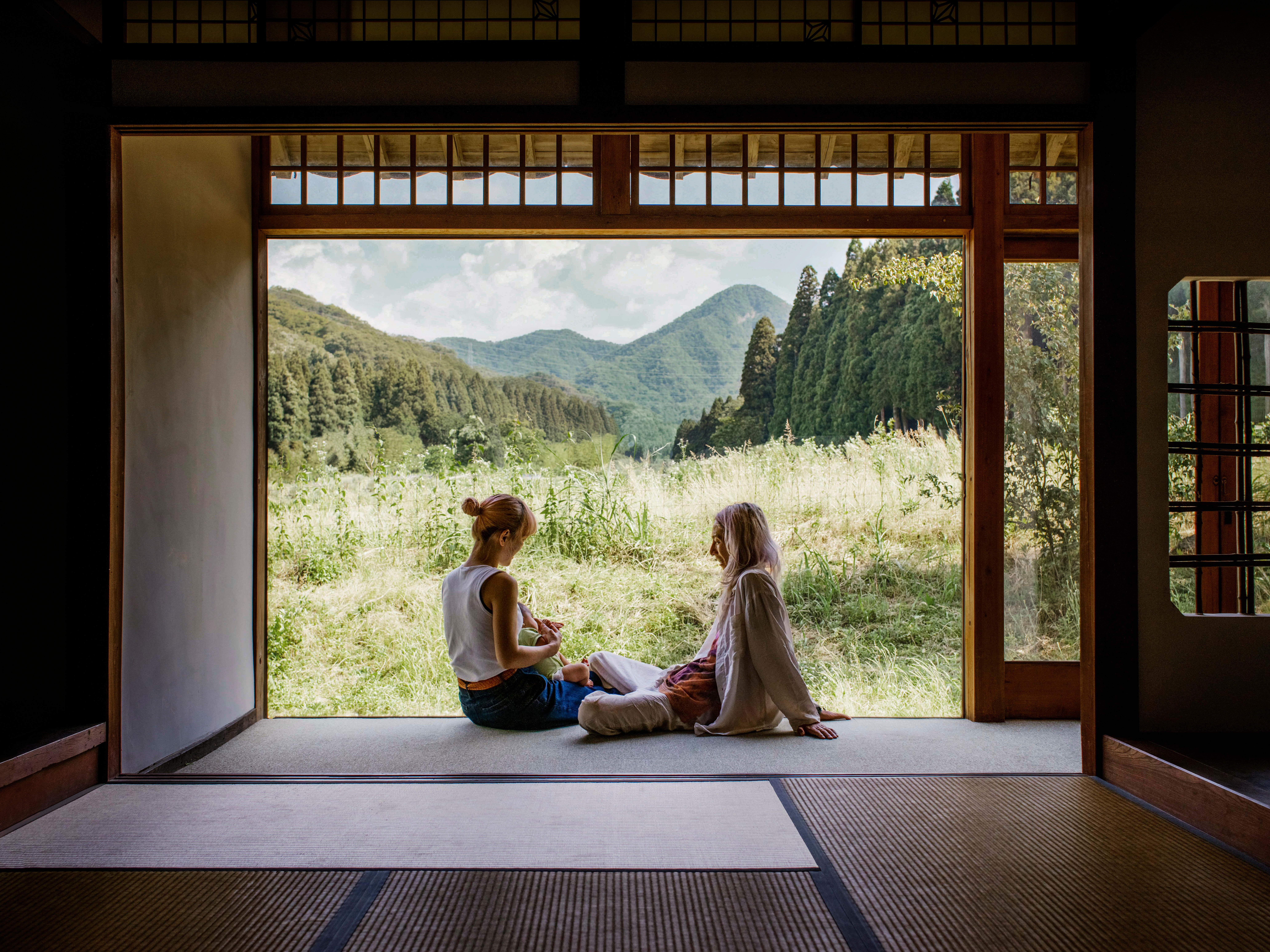 Two people sitting in their Airbnb rental in Japan.