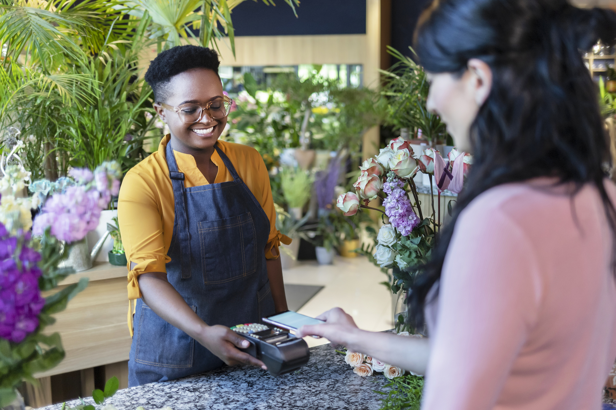 A person paying with a credit card in a store.