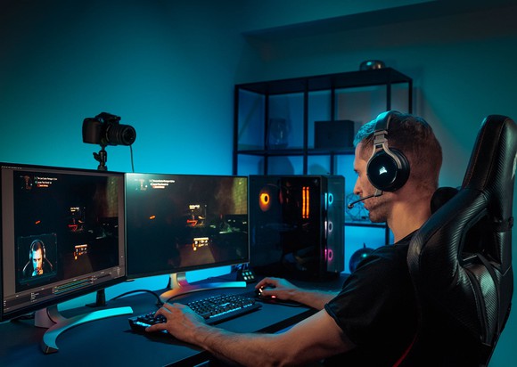 Playing games on a PC with three screens.