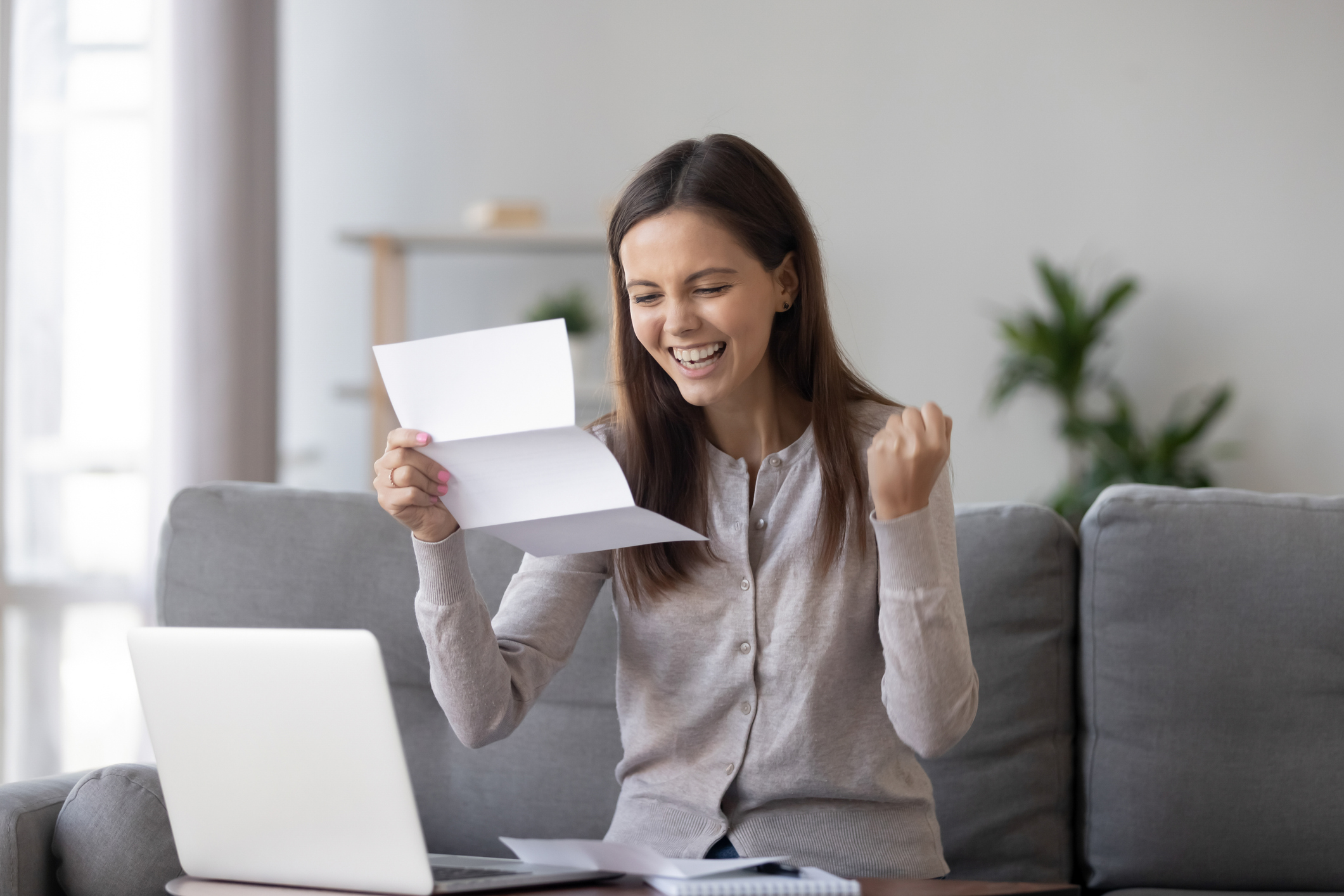 A woman finds out she's been approved for a loan.
