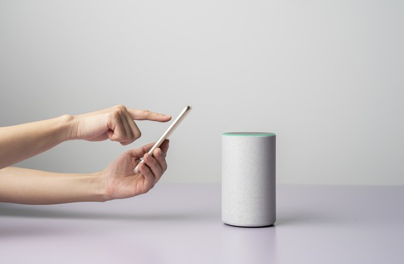 Two hands holding a smartphone trying to connect to a device.