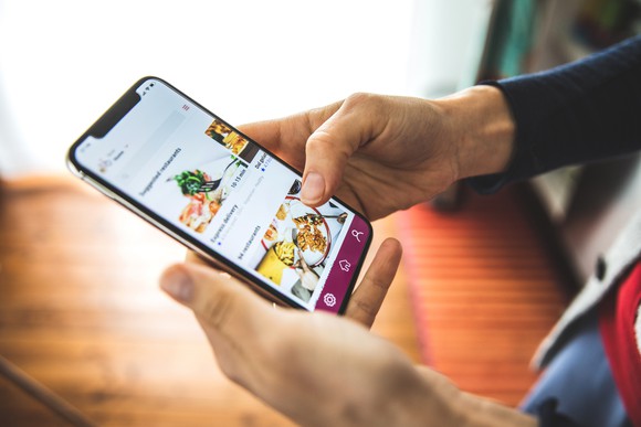 Closeup of smartphone open to a food delivery app. 