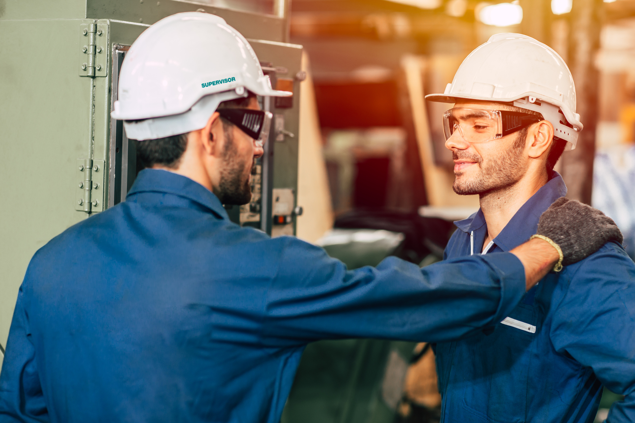 Industrial workers weaing corprate uniforms.