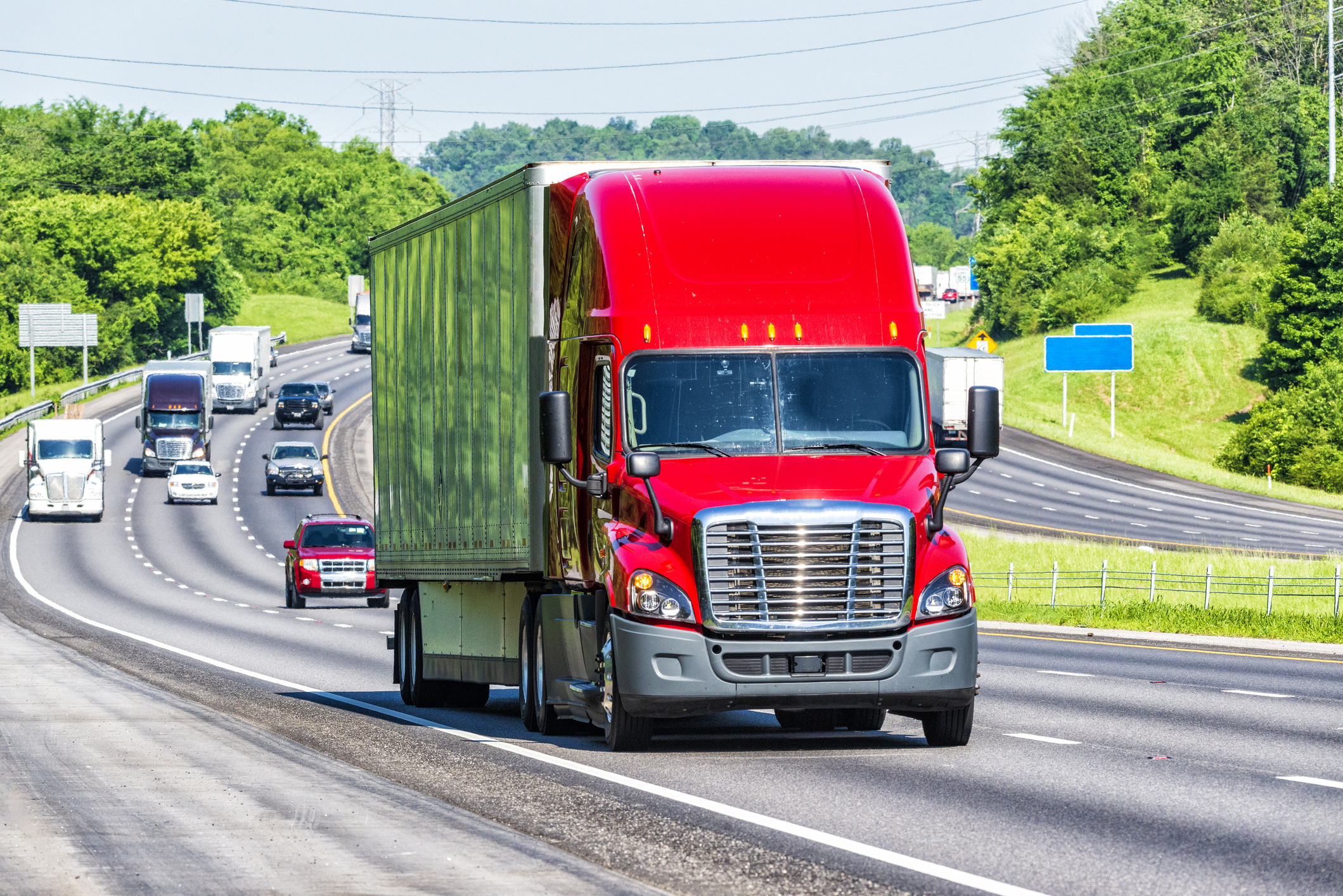 A semi-truck driving on a highway.