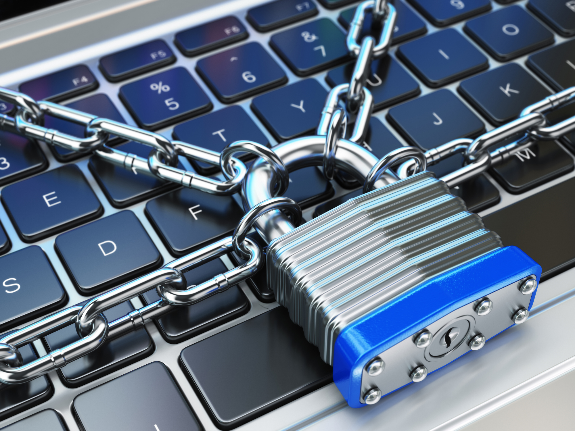 Padlock and chain on computer keyboard.