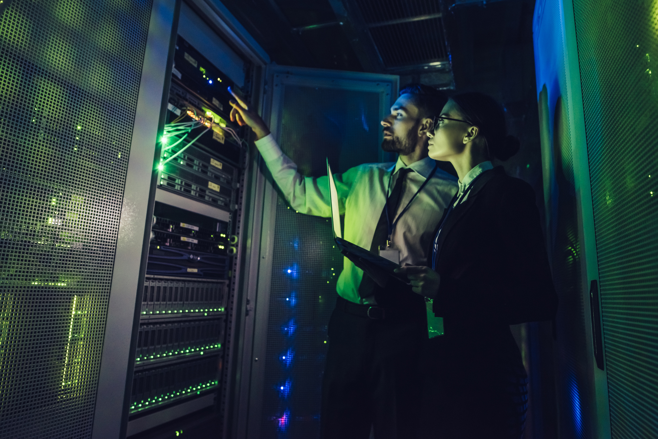Man and woman looking at servers