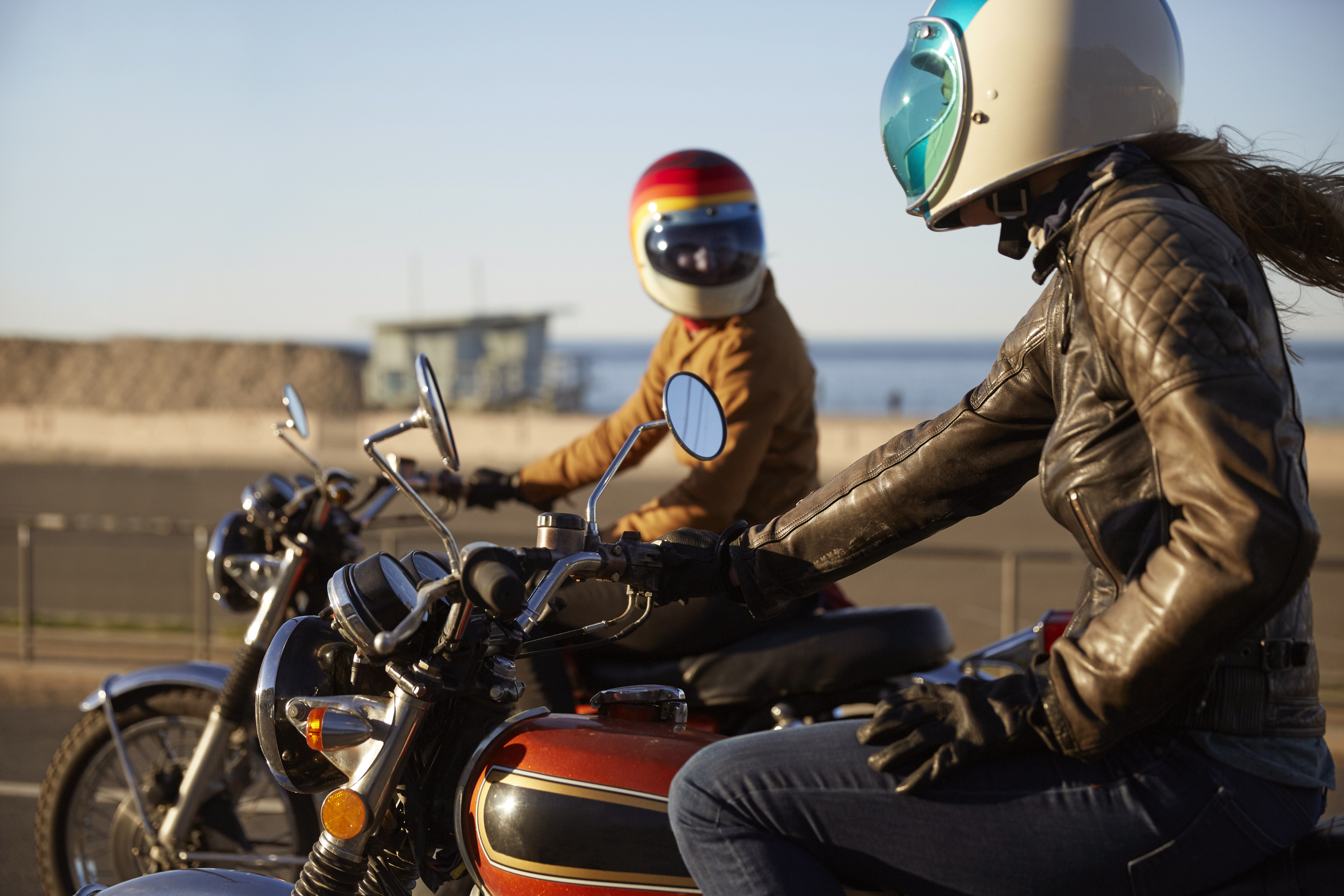 Two motorcyclists on light adventure motorcycles.