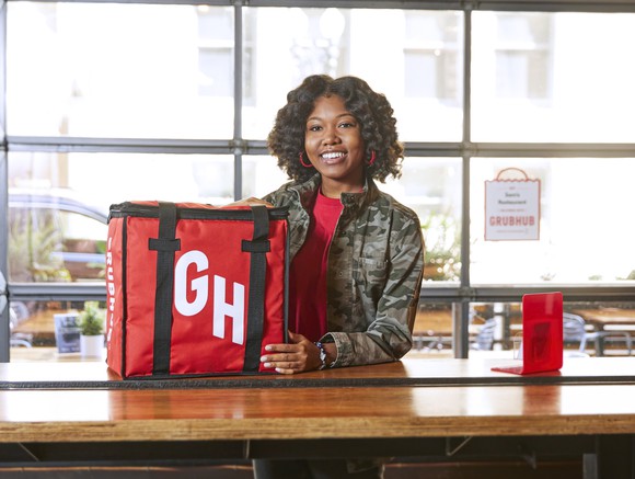 Grubhib delivery driver with a red delivery bag.