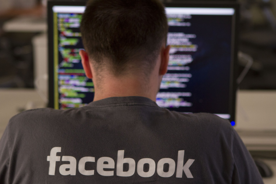 A Facebook engineer inputting computer code.