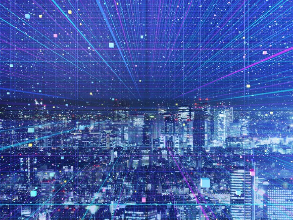 A cityscape at night, covered in digital color streaks.