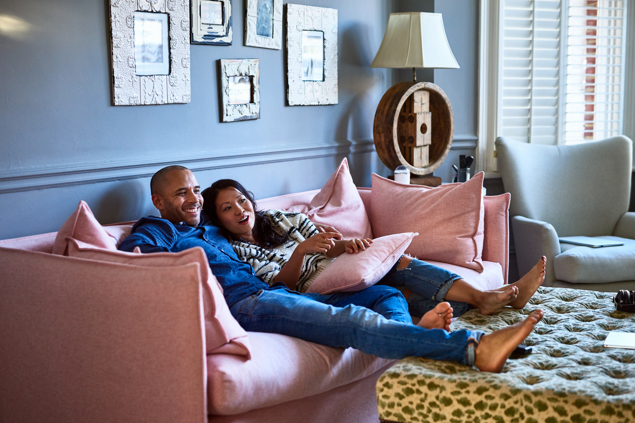 Two people lounging on a couch.