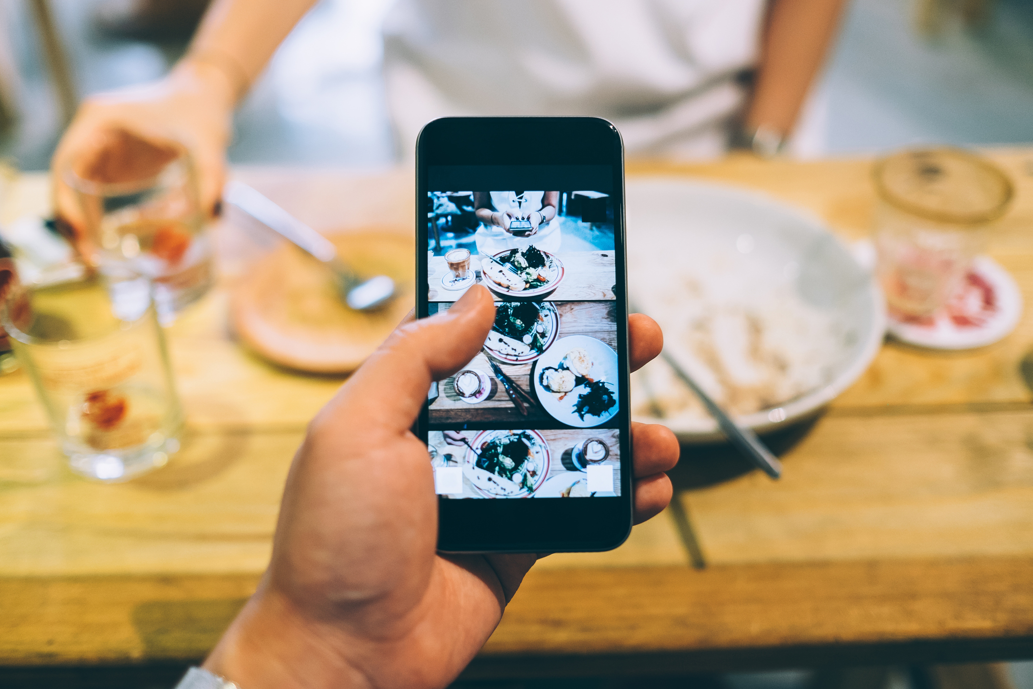Someone making social media post at a restaurant.