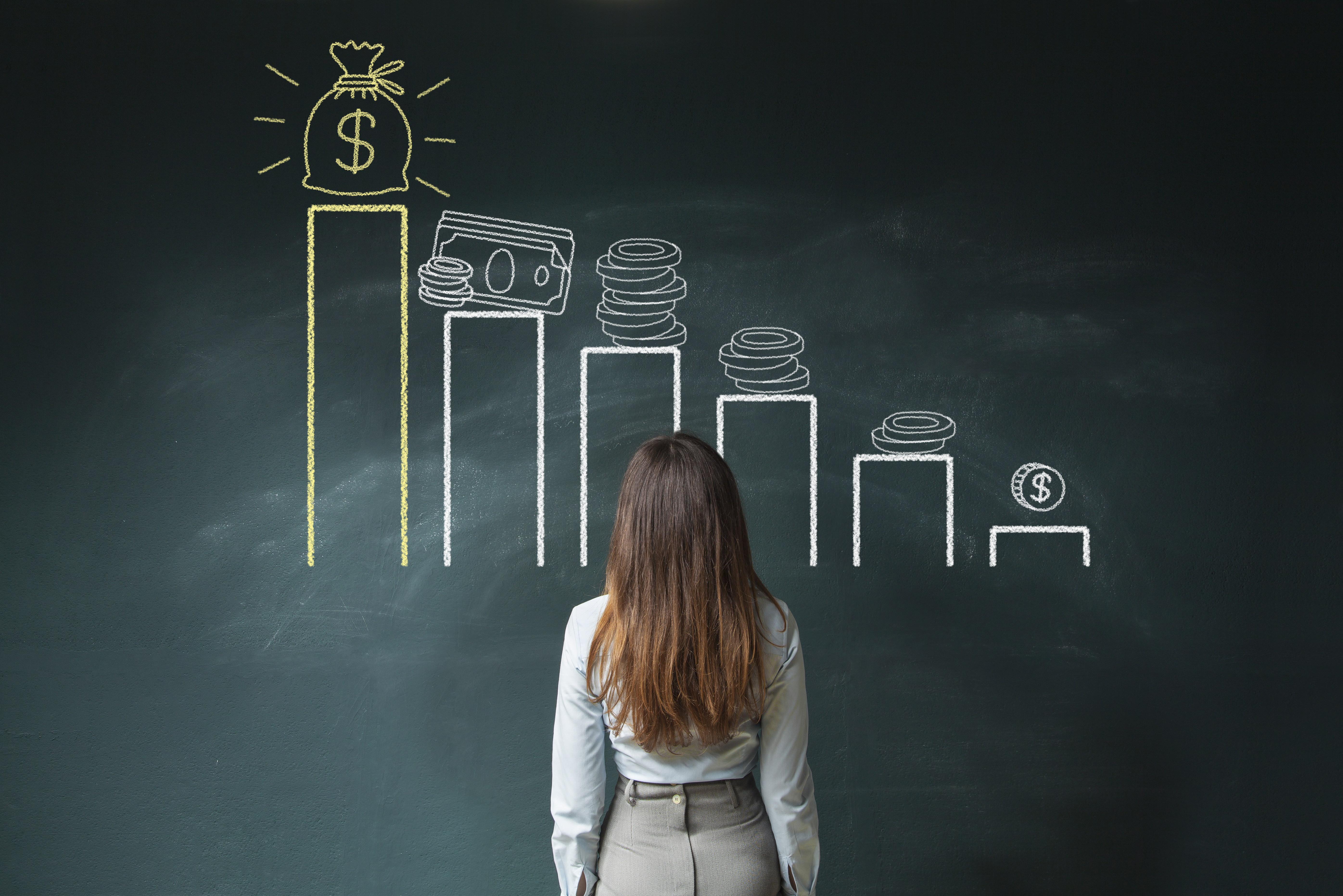 Person staring at a chart of money growth on a blackboard.