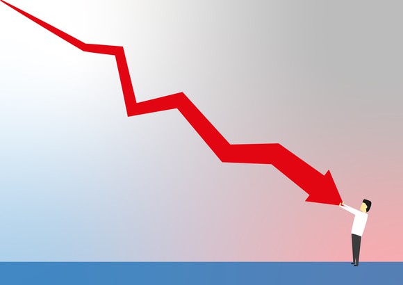 Man stopping a falling chart from falling any farther.