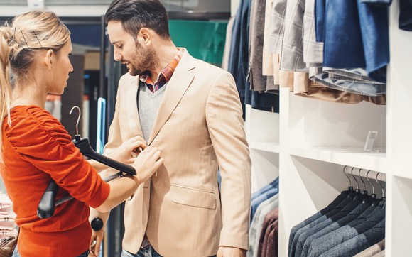 Man and woman shopping for a new sport coat.