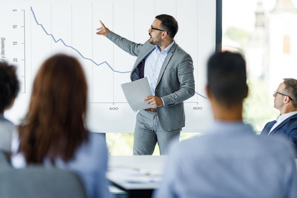 Investment advisor explaining a sinking stock chart.