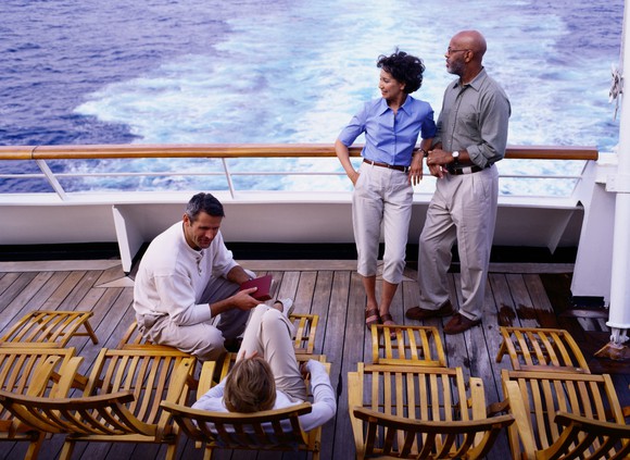 Couples standing on deck of cruise ship