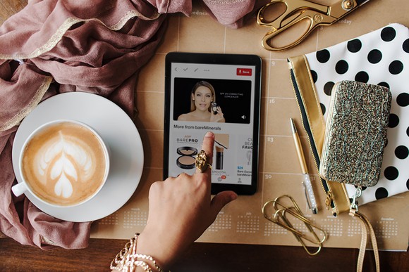 Person looking at Pinterest tutorial video on phone.