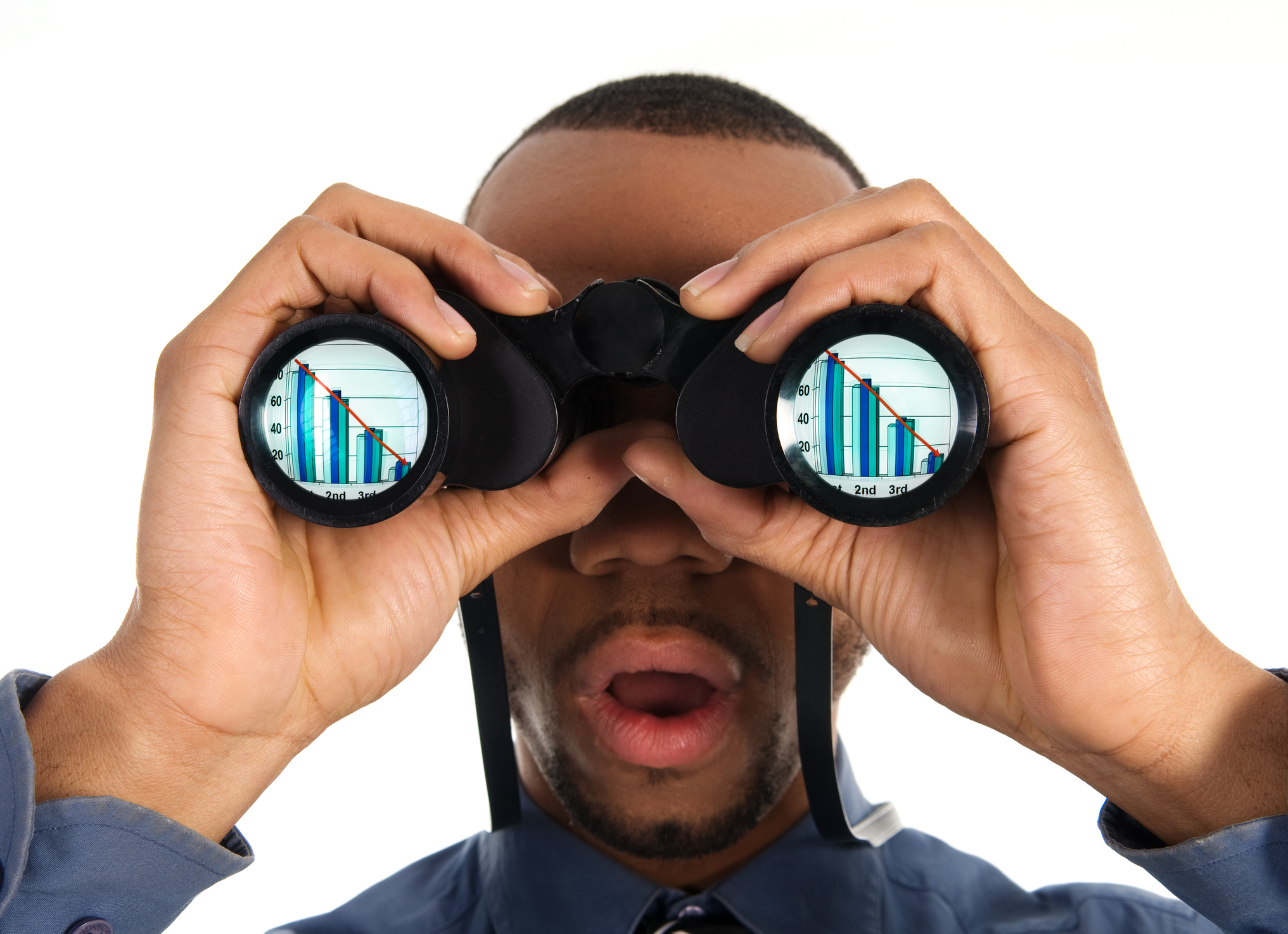 A person looks through binoculars that show declining bar charts in both lenses.