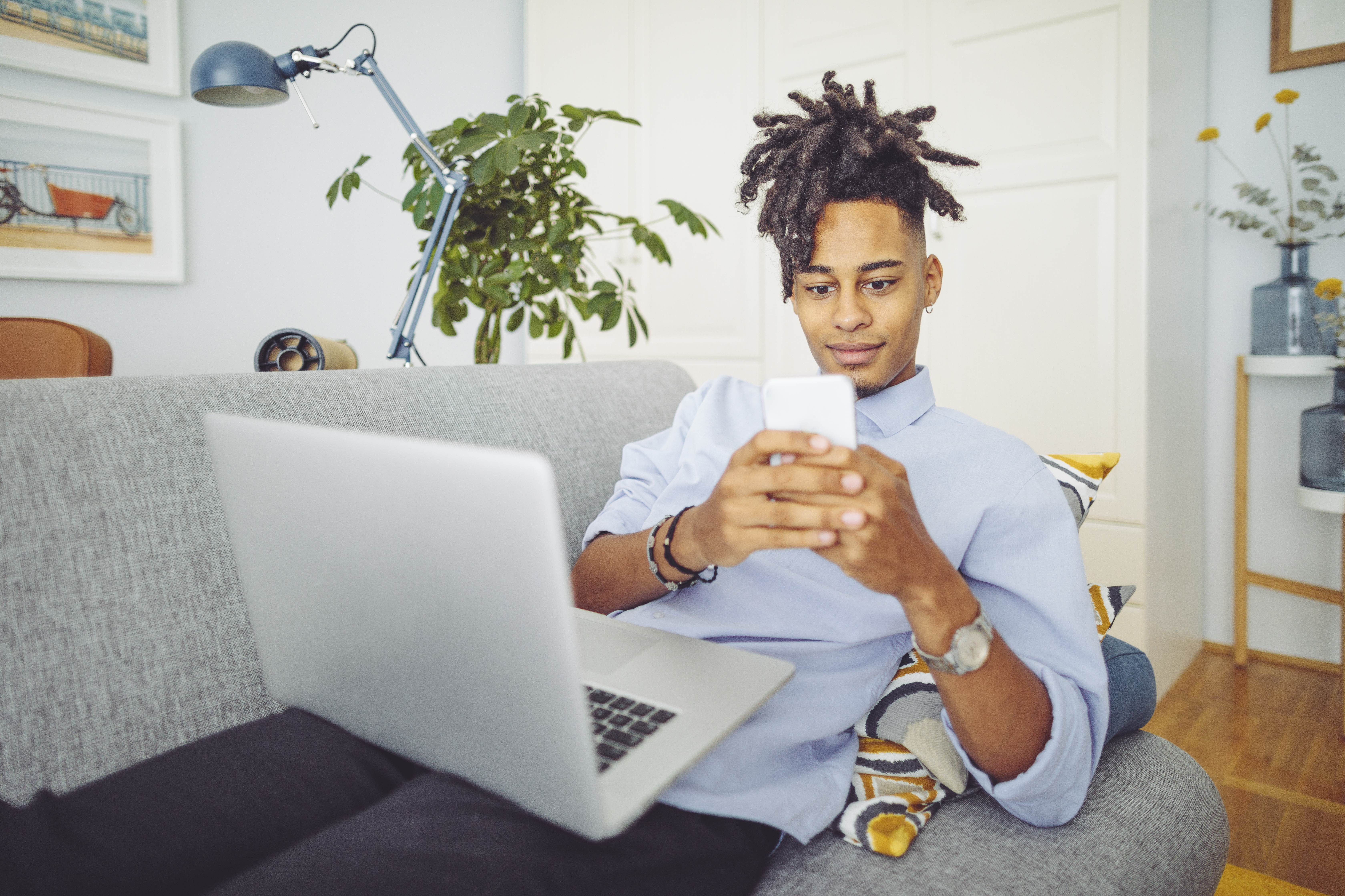 Teen on a laptop and cell phone