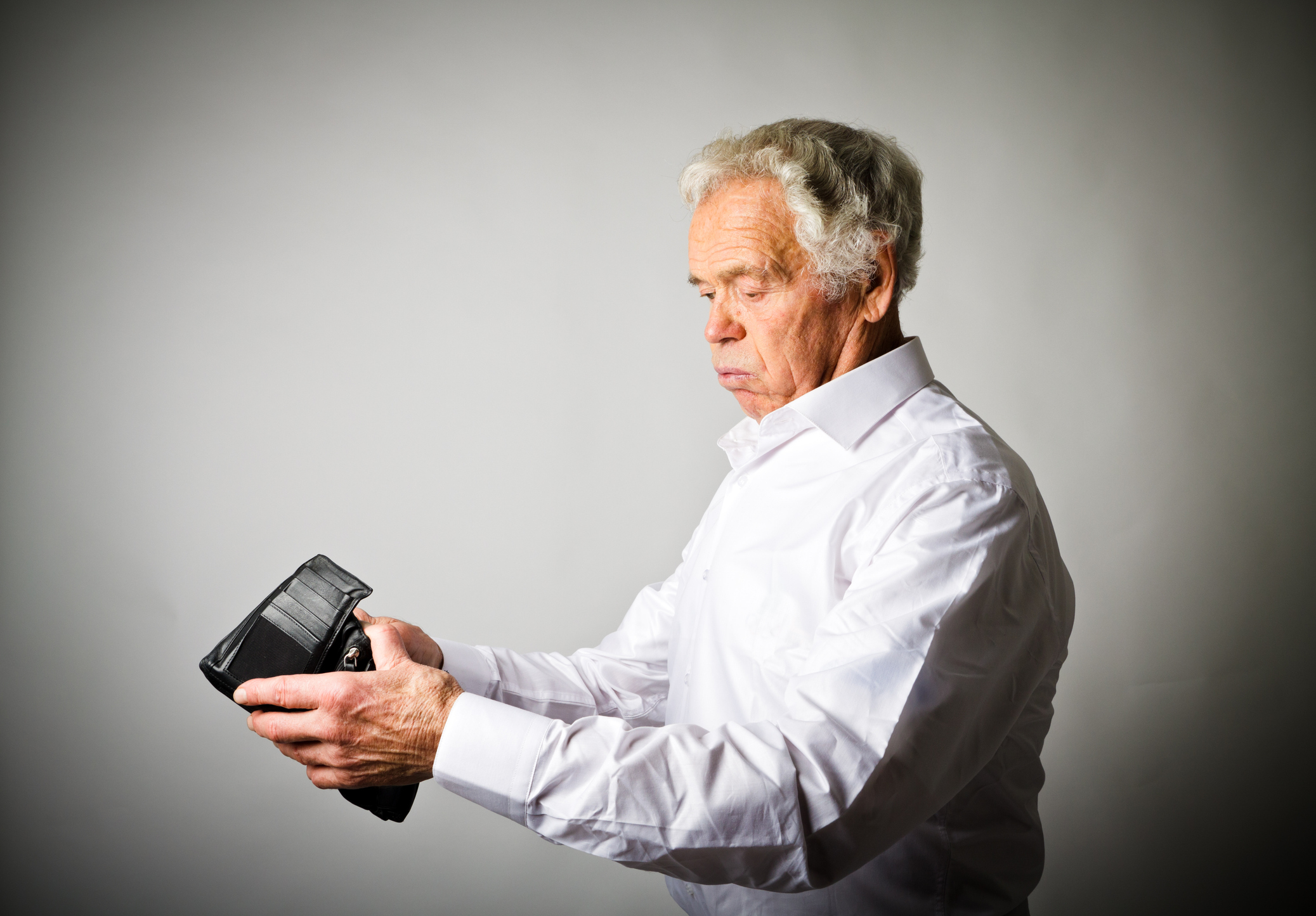 A senior looking into a wallet.
