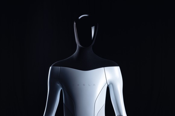 Tesla Bot, featuring a humanoid frame, white body, and black shoulders.