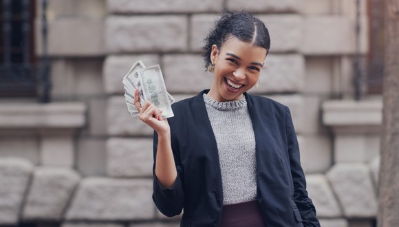 Happy person holding cash.