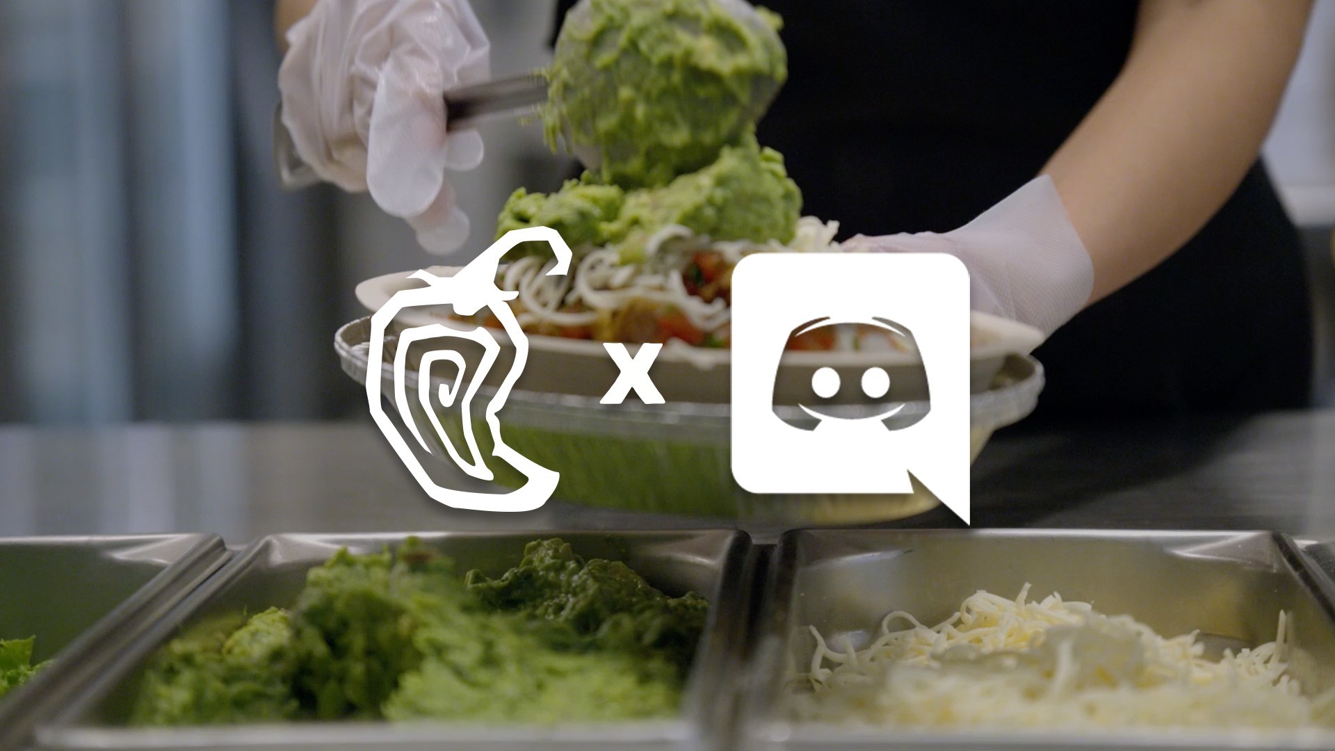 A Chipotle worker wearing sanitary gloves spoons guacamole onto a burrito bowl as icons for the company's ordering app are overlayed on the image