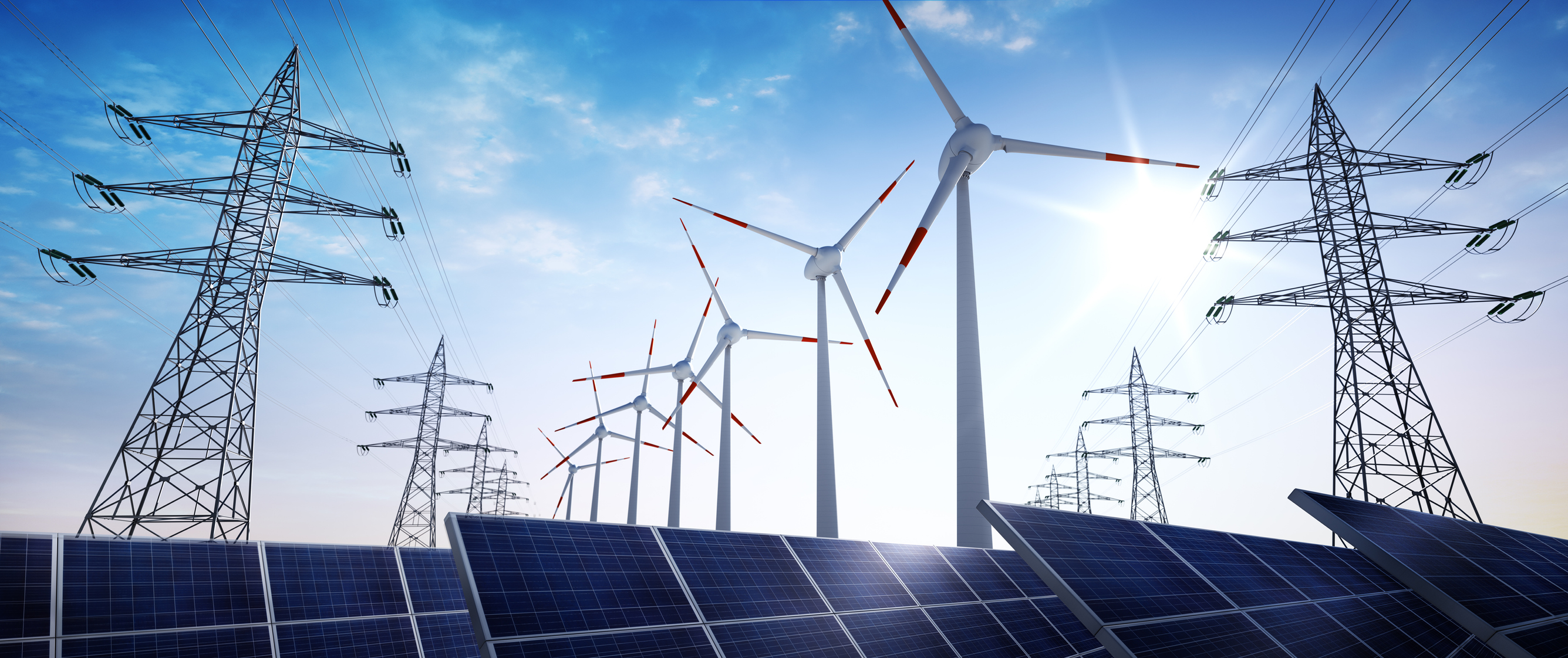 power transmission towers with solar panels and wind turbines.