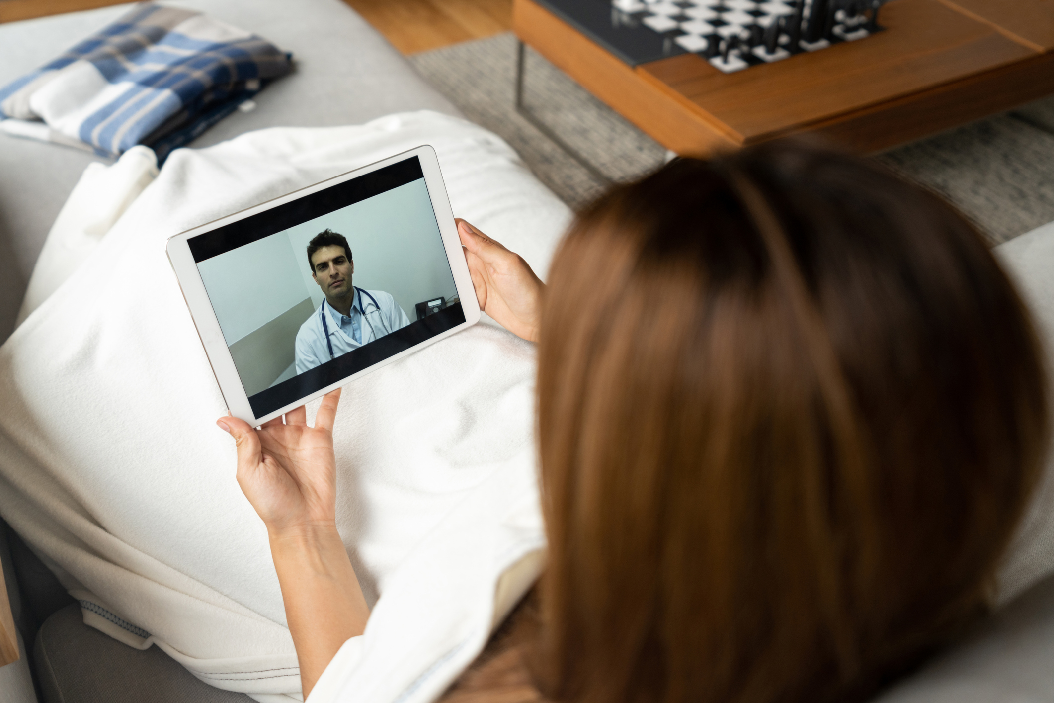 Patient talking to doctor via tablet.
