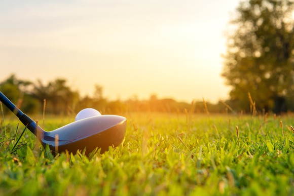 Golf club teed up with a club ready to hit. 