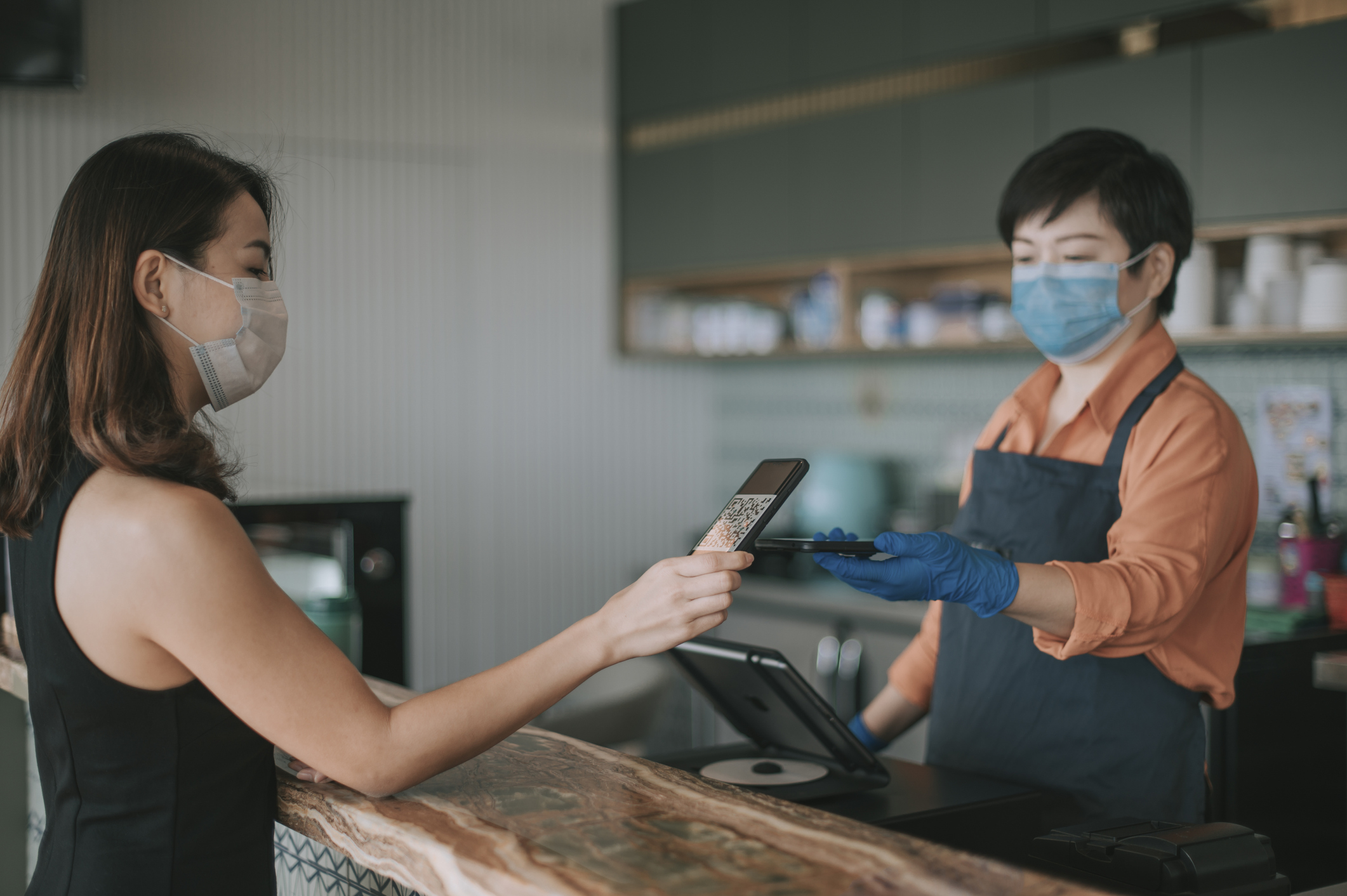 A customer uses a QR code on their smartphone to check out