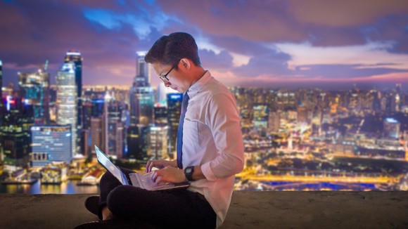 A person in Singapore uses a laptop.
