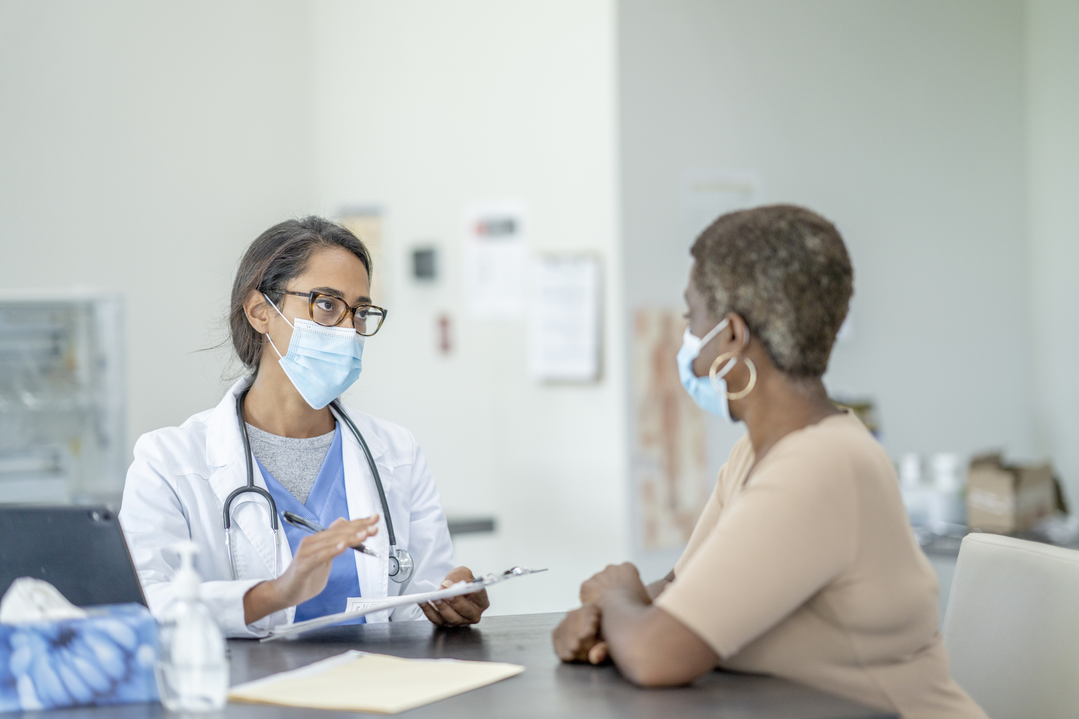 A patient meets with their doctor for an appointment.