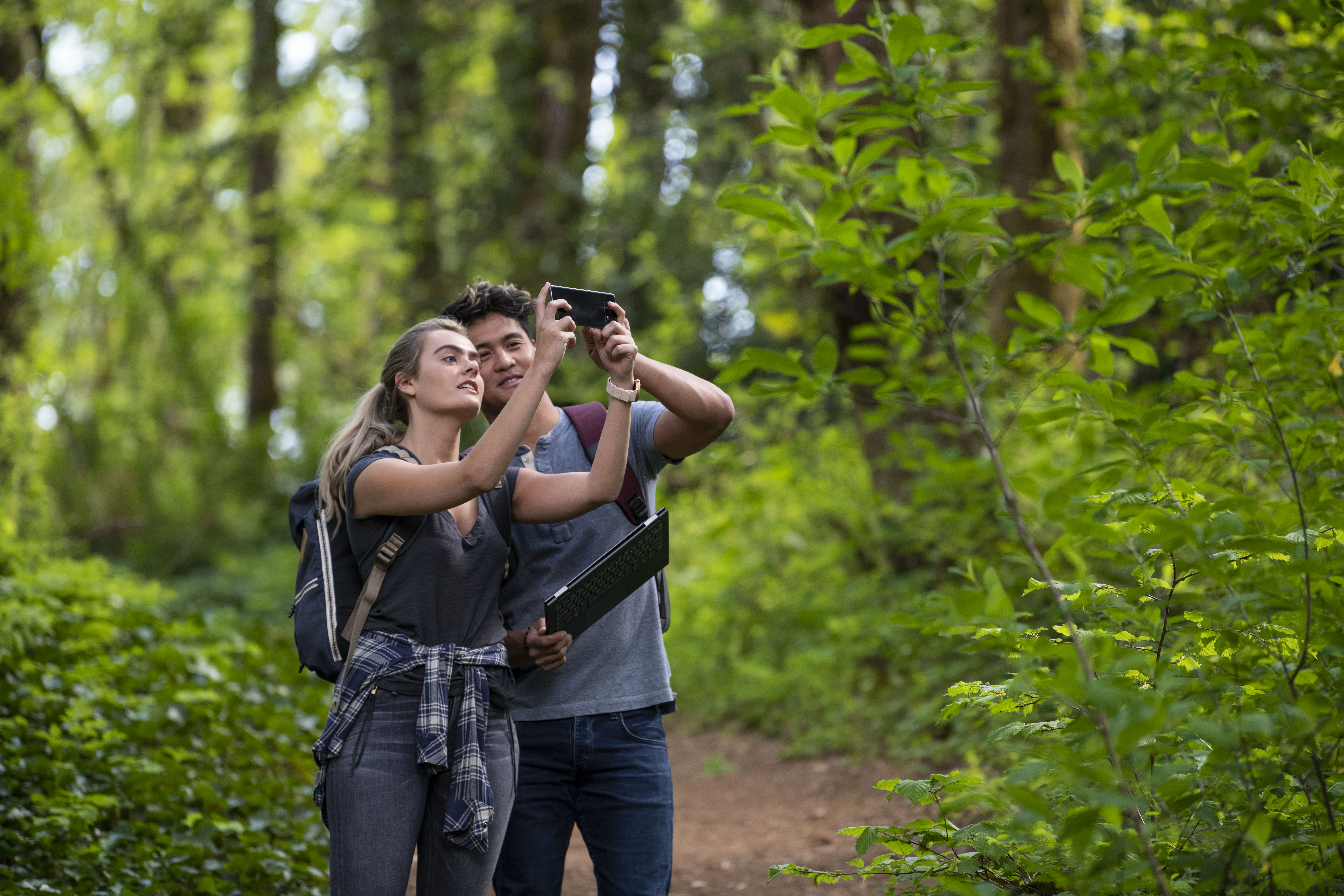 Couple exploring the wilderness with a connected mobile device.
