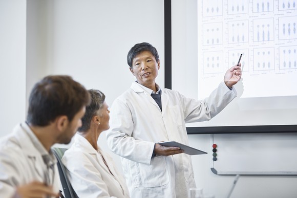 Scientist presenting positive clinical trial data.